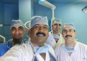 Dr. Rakesh Dhupia and two doctors with team perform surgery in an operating room in Indore